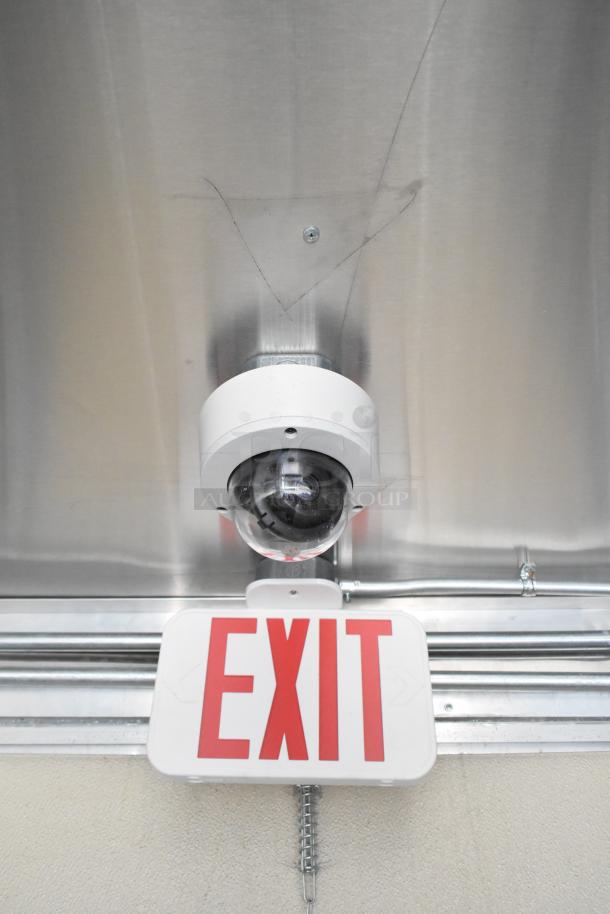 Security camera and exit sign inside a 2021 Diamond Cargo 8.5' x 24' food trailer.