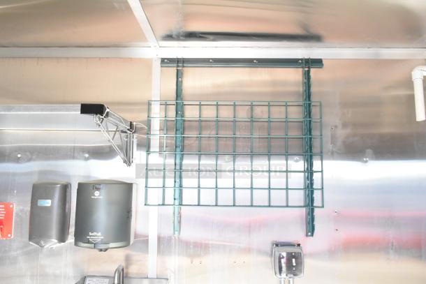 2021 Diamond Cargo 8.5' x 24' food trailer interior, showing grease hood, air conditioning system, and storage racks, in good condition.