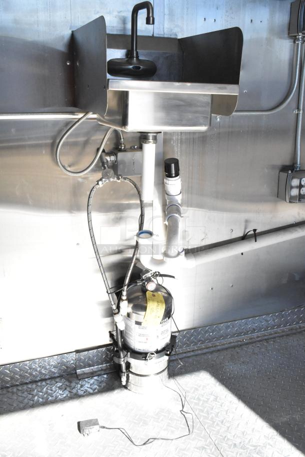 2021 Diamond Cargo food trailer interior sink with plumbing and fire suppression system visible. Stainless steel finish.