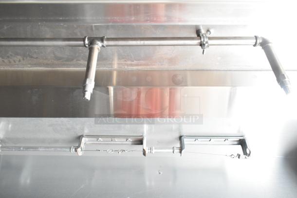 2021 Diamond Cargo food trailer interior, showcasing stainless steel grease hood and piping for ventilation system.