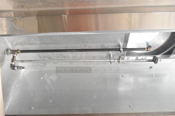 Interior view of a 2021 Diamond Cargo 8.5' x 24' food trailer featuring stainless steel grease hood and ventilation system.