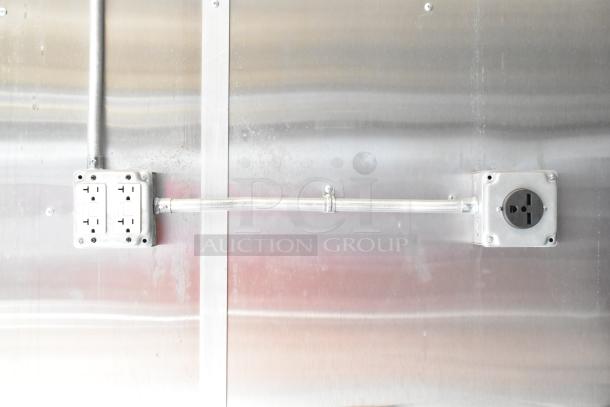 2021 Diamond Cargo food trailer electrical outlets on metal wall, showcasing installed wiring.