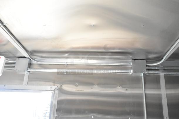 2021 Diamond Cargo 8.5' x 24' food trailer interior, showing metal construction and installed wiring. Includes grease hood and AC system.