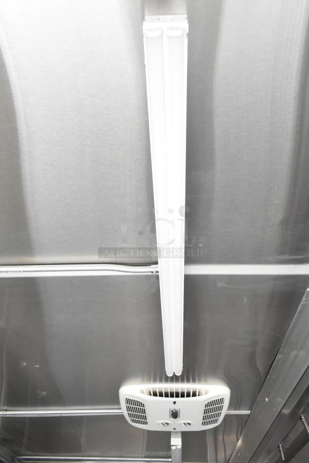 Interior view of 2021 Diamond Cargo 8.5' x 24' food trailer featuring ceiling-mounted fluorescent light and air conditioning vent.