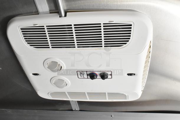 Interior view of a Diamond Cargo food trailer showing its integrated air conditioning system with adjustable vents and controls.