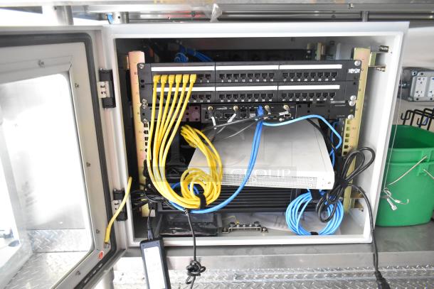 Interior of a 2021 Diamond Cargo trailer showing network cables and equipment storage. Model: 8.5' x 24'.