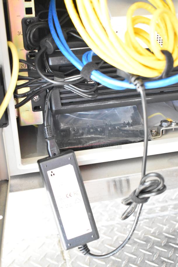 Electrical setup inside 2021 Diamond Cargo food trailer, highlighting cables and connections. Includes air conditioning.