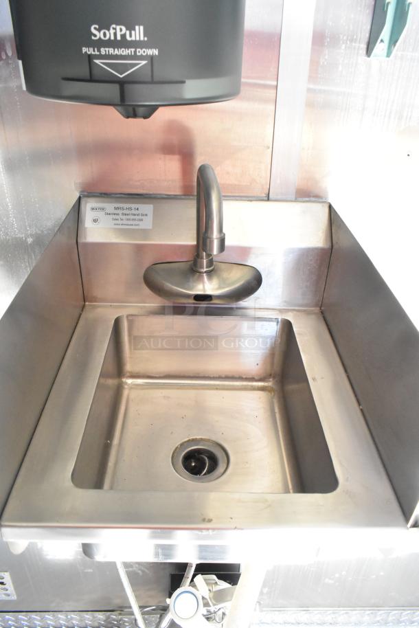 Stainless steel sink in 2021 Diamond Cargo food trailer. Includes sensor faucet, grease hood, and air conditioning.