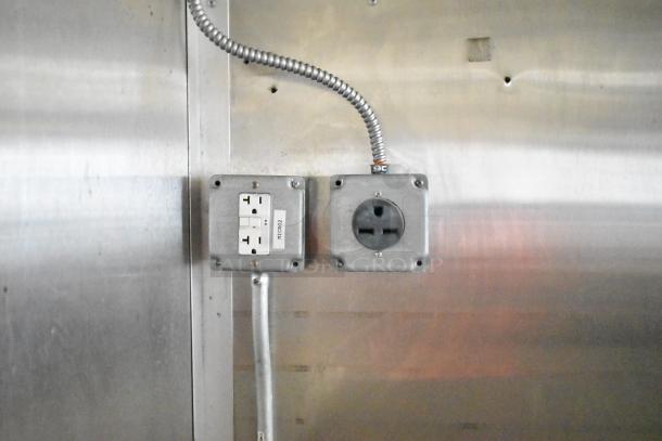 Electrical outlets inside the 2020 Diamond Cargo Mobile Kitchen Trailer. One labeled "Microwave."