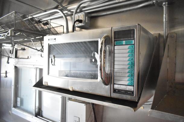 Sharp microwave oven inside 2020 Diamond Cargo 8.5' x 24' mobile kitchen trailer. Features visible buttons and stainless steel finish.