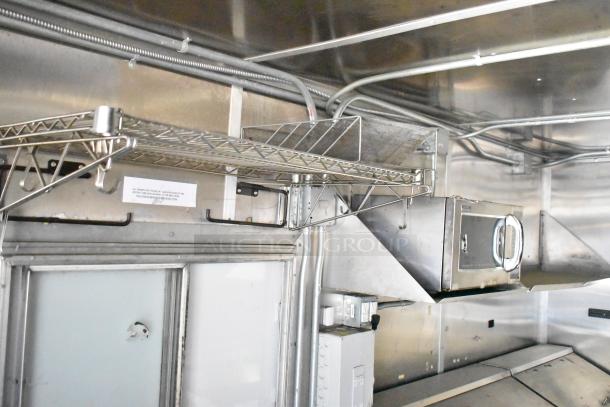 2020 Diamond Cargo mobile kitchen trailer interior with stainless steel shelving, grease hood, and equipment. Model VIN 53NBE2424M1083695.