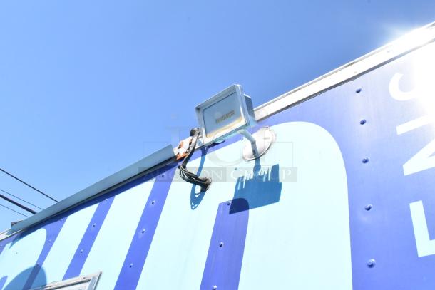 Roof edge of 2020 Diamond Cargo mobile kitchen trailer with mounted light fixture, featuring blue exterior.