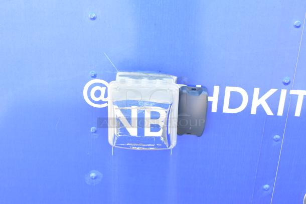 Blue exterior of the 2020 Diamond Cargo Mobile Kitchen Trailer with text and clear cover.