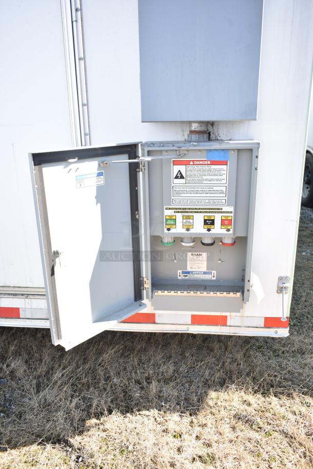 2021 Diamond Cargo 8.5' x 24' trailer power panel; open with color-coded connections, warning and safety labels visible.