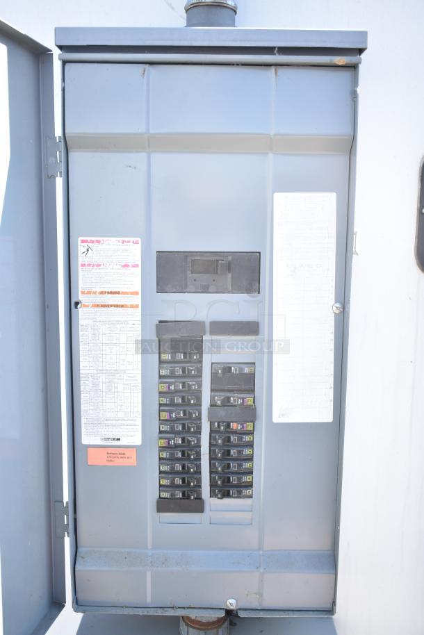 Electrical panel inside the 2021 Diamond Cargo 8.5' x 24' trailer, showing circuit breakers and safety labels.