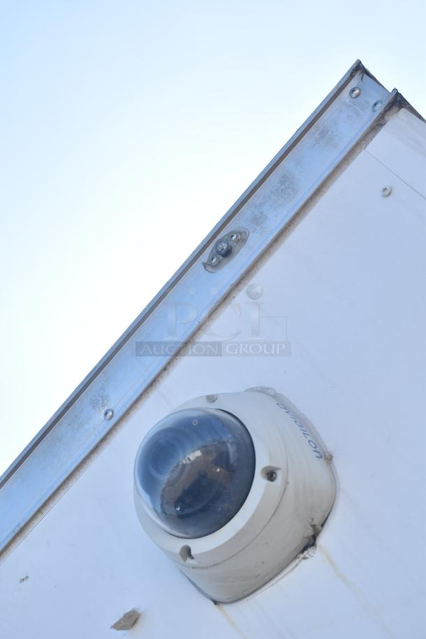 Security camera mounted on Diamond Cargo food and beverage trailer, featuring Avigilon branding, visible metal edge.