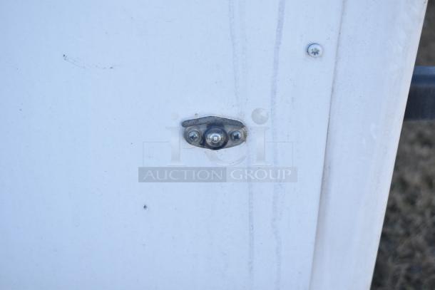 Close-up of 2021 Diamond Cargo trailer exterior, focusing on metal rivet details, showing condition and build quality.