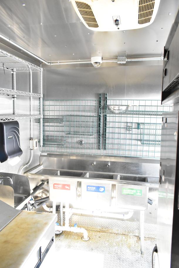 2021 Diamond Cargo 8.5' x 24' trailer interior with stainless steel sink, wire shelving, and ceiling ventilation. VIN 53NBE2429M1089847.