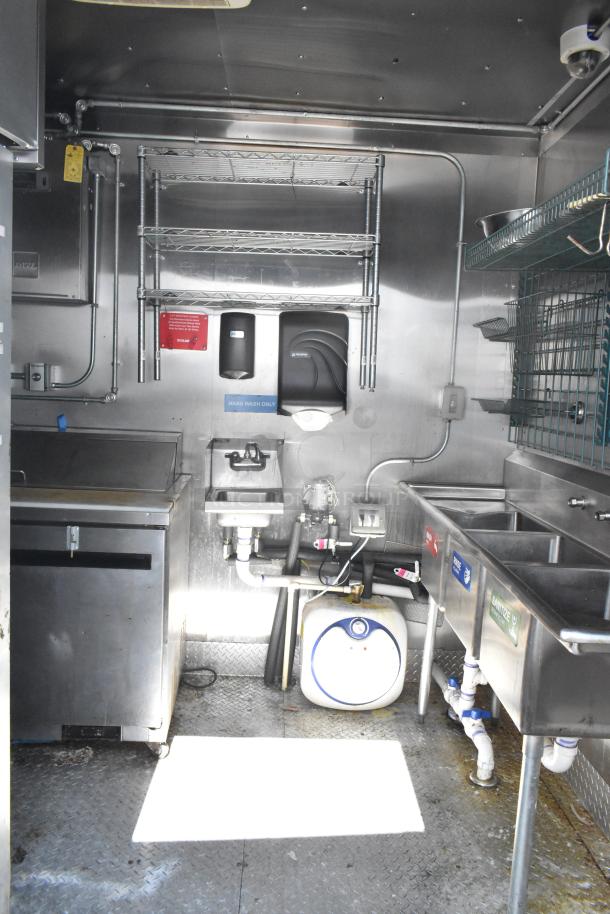 2021 Diamond Cargo 8.5' x 24' trailer interior, with stainless steel equipment, hand wash sink, and storage racks, VIN visible.