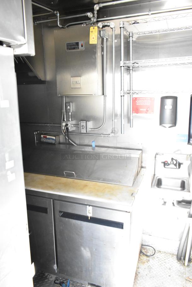 2021 Diamond Cargo 8.5' x 24' cold food trailer interior, featuring stainless steel prep area, shelving, and utility sink.
