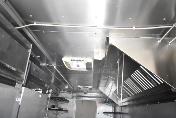 Interior of 2021 Diamond Cargo 8.5' x 24' cold food trailer, featuring stainless steel surfaces, shelving, and ventilation.
