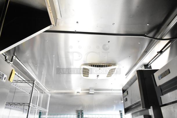 Interior view of 2021 Diamond Cargo 8.5' x 24' cold food trailer. Features stainless steel shelving and climate control unit.