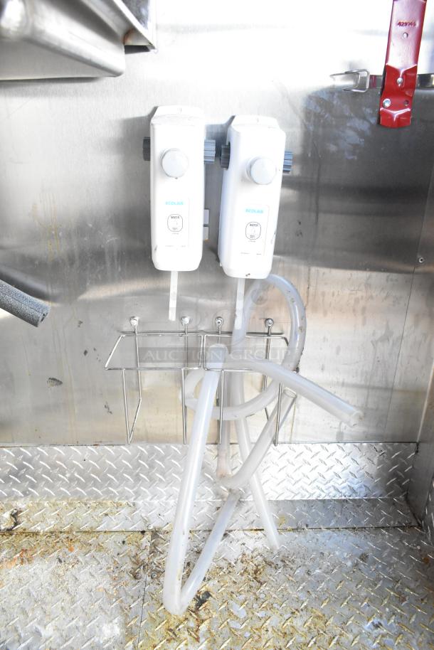 2021 Diamond Cargo 8.5' x 24' trailer interior with Ecolab dispensers, hoses, and a stainless steel wall. Condition shows usage.