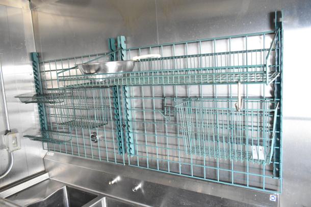 Interior of 2021 Diamond Cargo 8.5' x 24' trailer, featuring blue wire shelving, stainless steel surfaces, and utility sink.