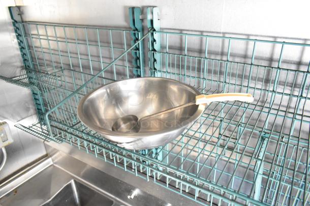 2021 Diamond Cargo 8.5' x 24' trailer interior with metal racks, stainless steel bowl, and ladle, showcasing storage capacity.