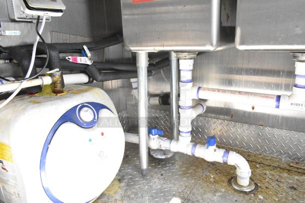 2021 Diamond Cargo 8.5' x 24' trailer interior, showing plumbing and storage components. Clean and well-maintained.