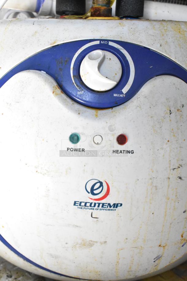 Eccotemp heater control panel with power and heating indicators, showing rust and wear.