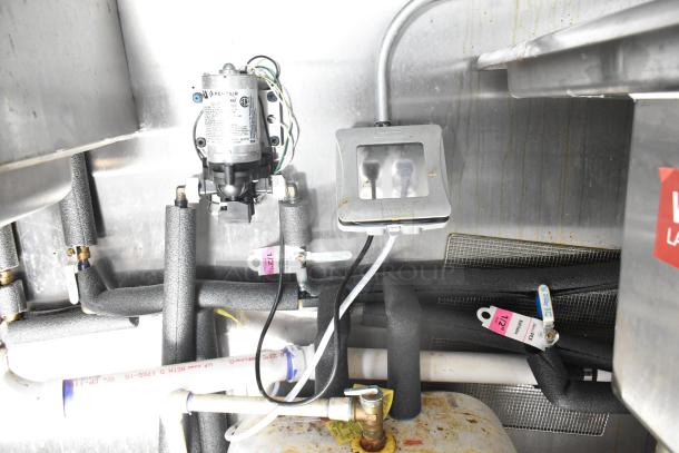 Interior view of a 2021 Diamond Cargo 8.5' x 24' Cold Food & Beverage Fulfillment Trailer, showing plumbing and electrical components.