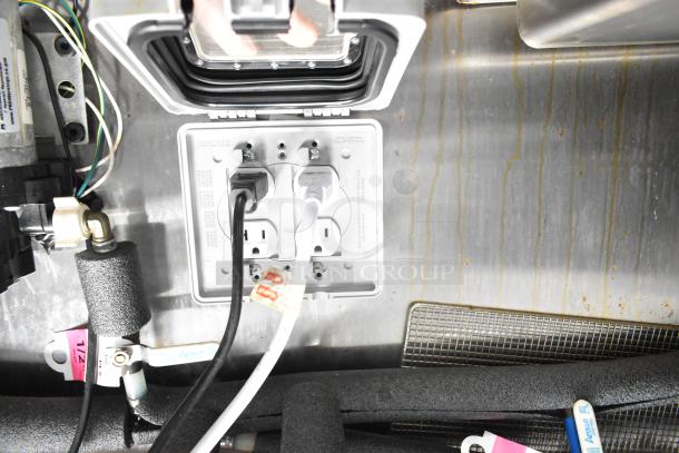 2021 Diamond Cargo trailer interior. Electrical setup with outlets and cables. Clean condition. VIN 53NBE2429M1089847 visible.