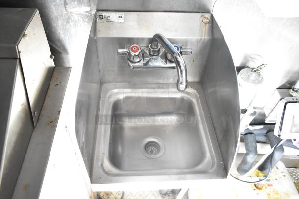 Stainless steel sink inside 2021 Diamond Cargo trailer. Features dual handle faucet, well-maintained condition.