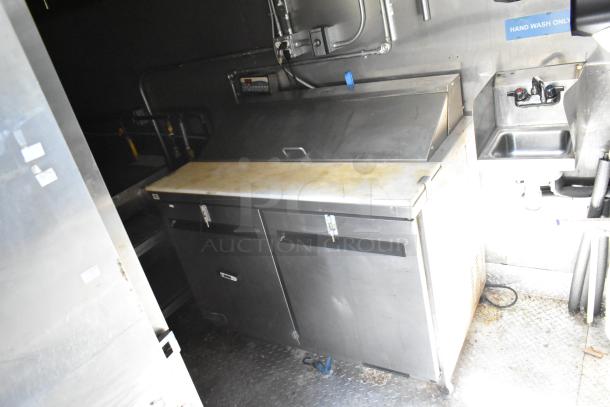 2021 Diamond Cargo 8.5' x 24' trailer interior, features stainless steel prep area, sink, and refrigeration unit, used condition.