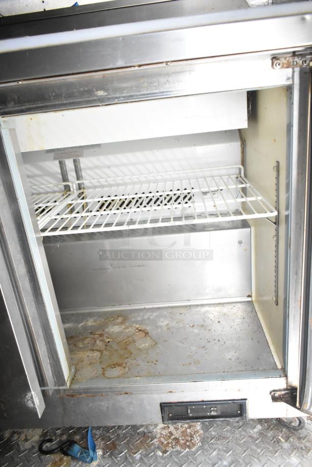 2021 Diamond Cargo 8.5' x 24' trailer interior, used cold storage unit with visible wear and rust on shelves and door frame.