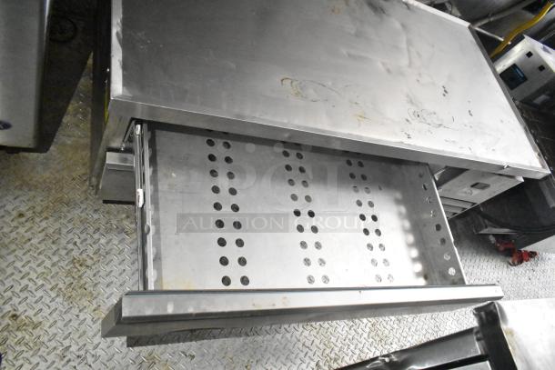 2021 Diamond Cargo trailer interior detail showing a metal drawer with perforated bottom, suitable for cold storage.
