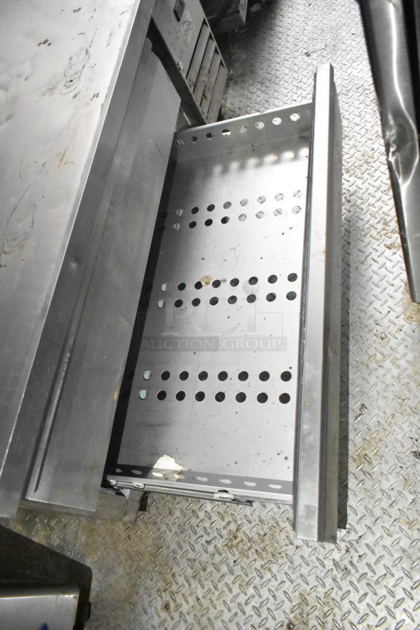 2021 Diamond Cargo cold food trailer interior with stainless steel shelves, perforated metal design, showing slight wear.