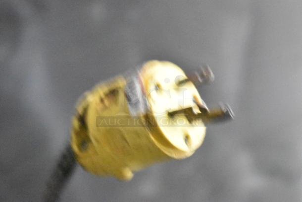 Close-up of a yellow electrical plug for a 2021 Diamond Cargo 8.5' x 24' cold food and beverage trailer, VIN 53NBE2429M1089847.