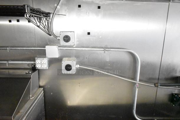 Interior view of a 2021 Diamond Cargo cold food & beverage trailer, showing electrical outlets and stainless steel walls.