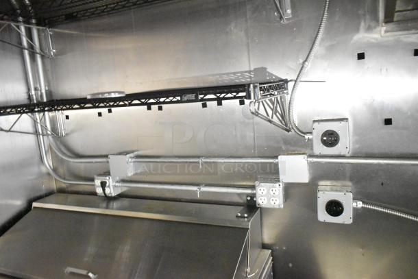 2021 Diamond Cargo 8.5' x 24' trailer interior, showcasing wiring, outlets, and stainless steel shelving for food storage.