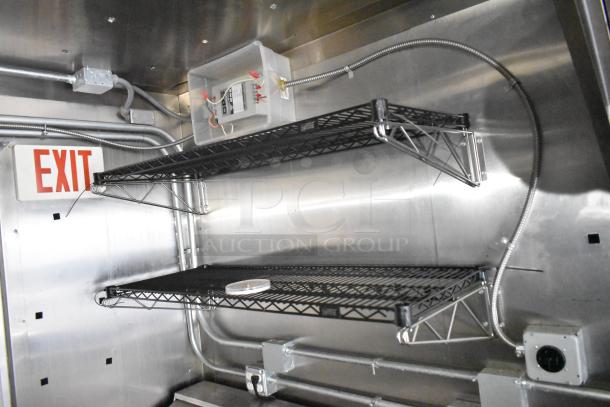 2021 Diamond Cargo 8.5' x 24' trailer interior with steel shelves, electrical wiring, and exit sign. Clean condition.