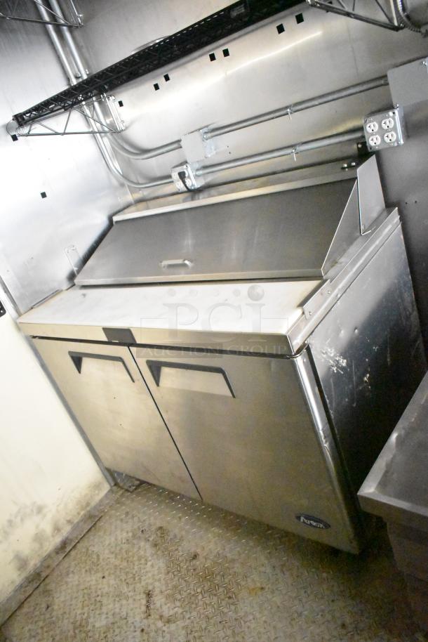 2021 Diamond Cargo 8.5' x 24' trailer interior, featuring a stainless steel cooler with double doors, some scuff marks visible.