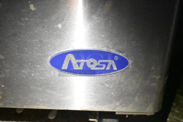 A stainless steel panel with an Atosa logo in blue on a 2021 Diamond Cargo cold food trailer.