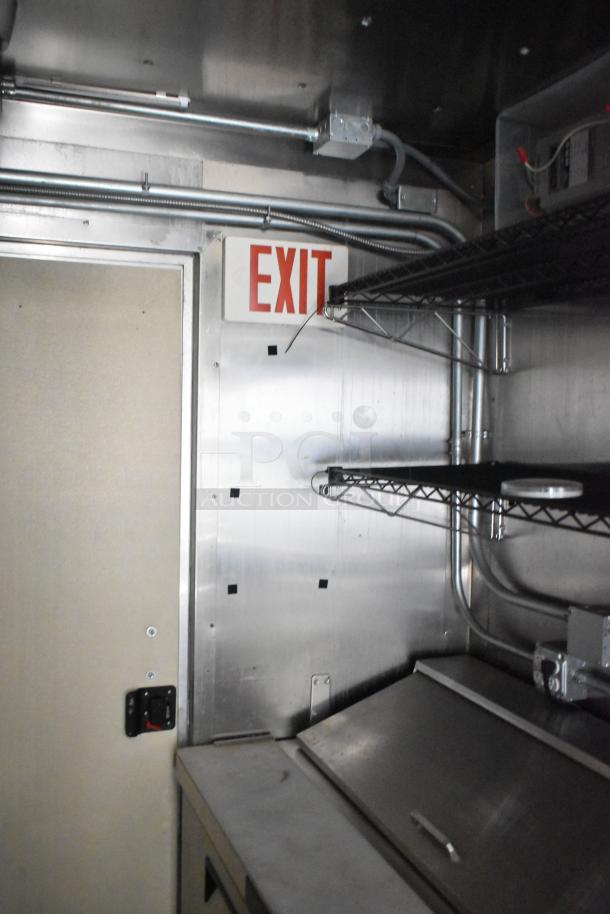 2021 Diamond Cargo 8.5' x 24' food trailer interior, stainless steel walls, shelving, exit sign, clean condition.