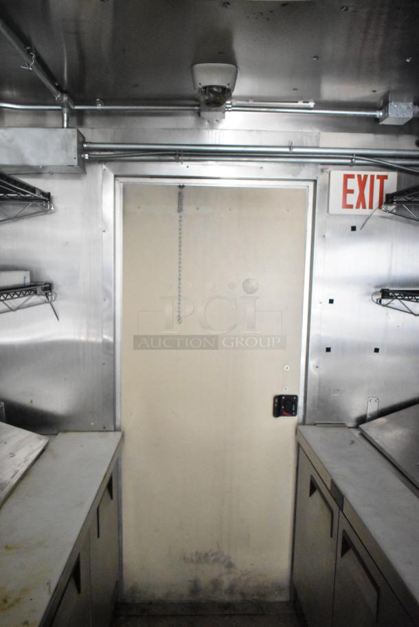 2021 Diamond Cargo 8.5' x 24' trailer interior with stainless steel counters, shelving, and insulation visible. Exit sign above door.