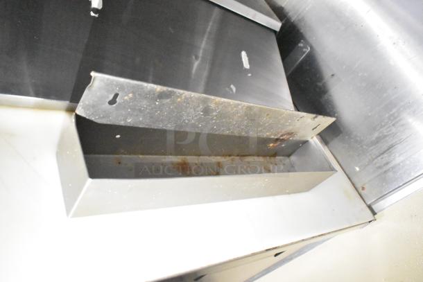 2021 Diamond Cargo 8.5' x 24' trailer interior view, stainless steel shelving with visible rust. VIN 53NBE2429M1089847.