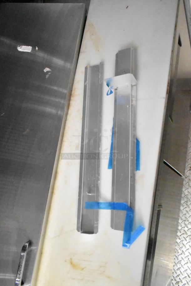 Interior view of a 2021 Diamond Cargo 8.5' x 24' food trailer, showing aluminum components on a metal surface.