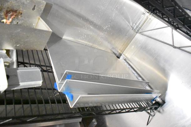 Interior view of a 2021 Diamond Cargo 8.5' x 24' cold food trailer, showing metal shelving and fixtures in good condition.