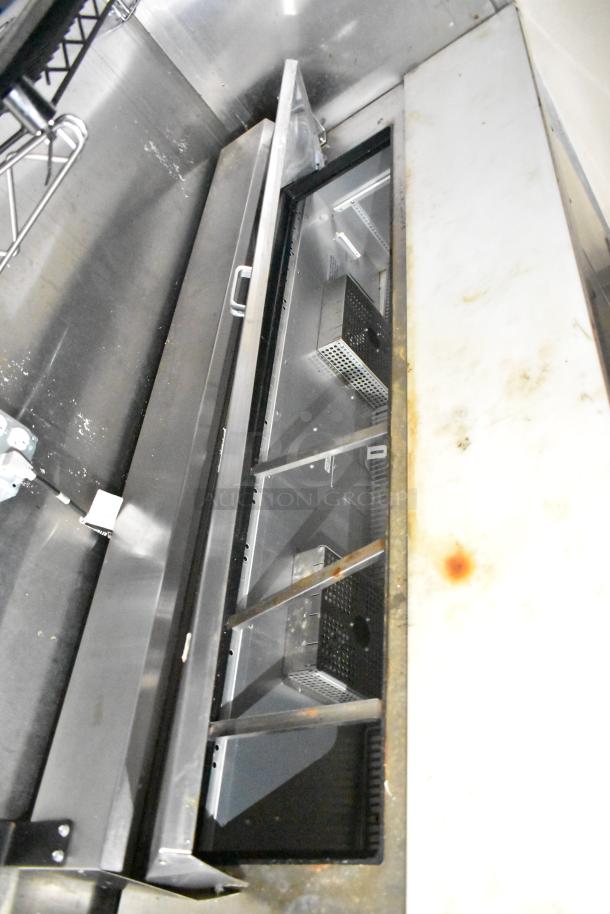 2021 Diamond Cargo 8.5' x 24' cold food trailer interior, featuring stainless steel surfaces and storage compartments.